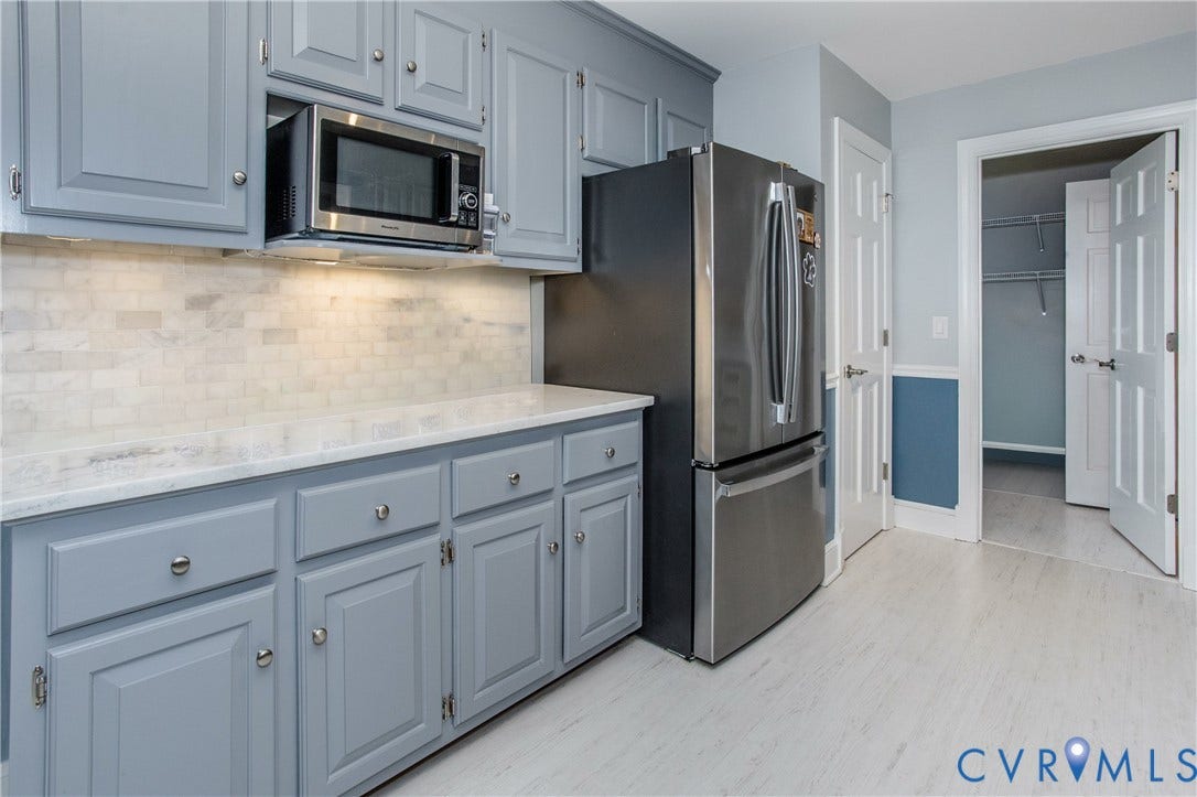 14530 Fox Knoll Drive, South Chesterfield, VA 23834 Light gray cabinetry with brushed nickel hardware, white stone-finish countertops, subway tile backsplash, and light wood-finish flooring