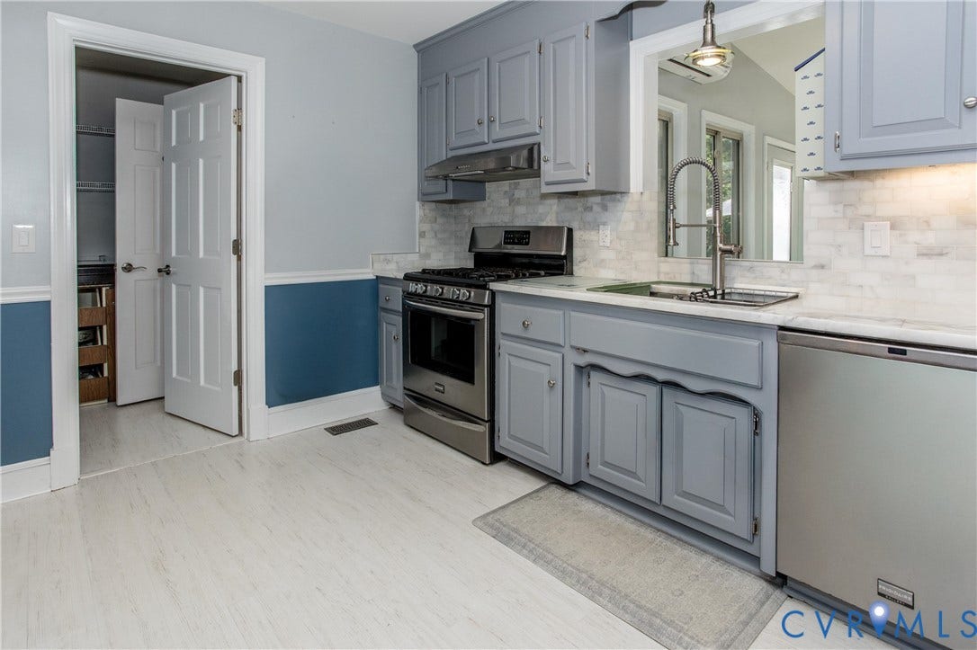14530 Fox Knoll Drive, South Chesterfield, VA 23834 Kitchen featuring wood-finish flooring, stainless steel appliances, light gray cabinetry, and a white tile backsplash