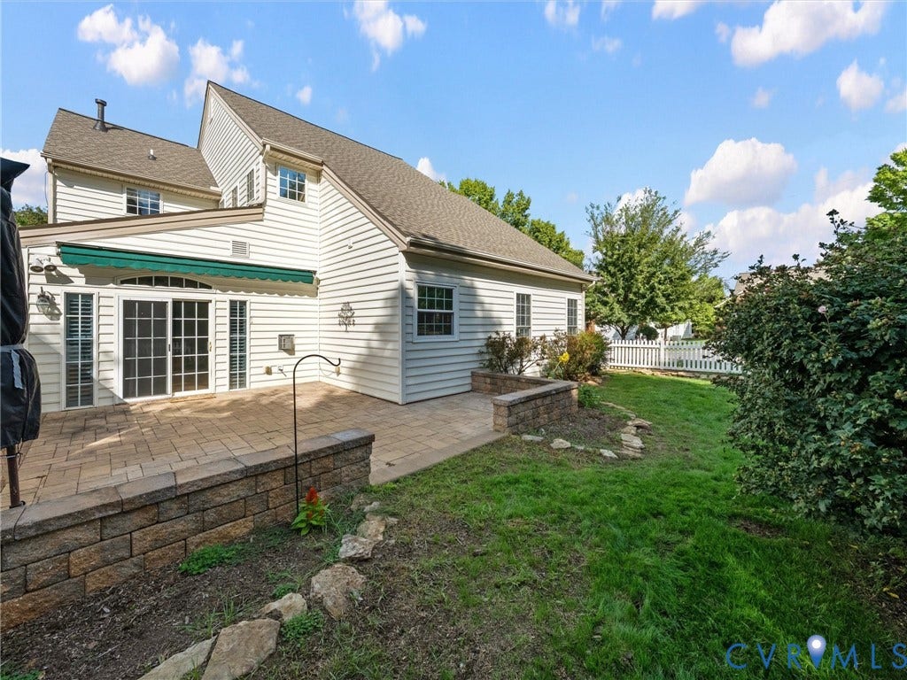 3824 Coles Point Way, Glen Allen, VA 23060 Paved patio with decorative retaining wall, awning, sliding glass doors, and white picket fencing