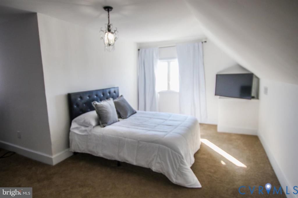 1910 W Main Street, The Historic Fan District, Richmond, VA 23220 Vaulted ceilings with a decorative chandelier, wall-mounted television, and carpeting