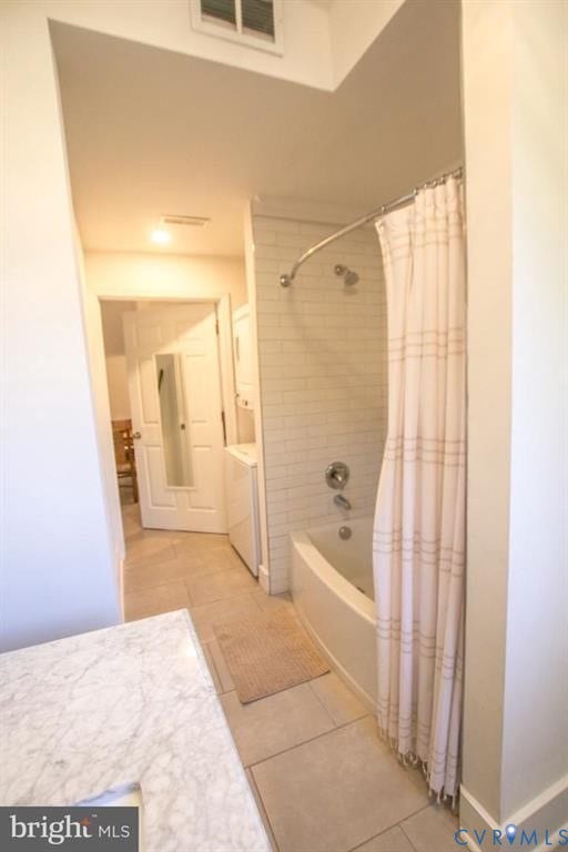 1910 W Main Street, The Historic Fan District, Richmond, VA 23220 Bathtub with subway tile surround, polished chrome fixtures, and light-toned floor tiling