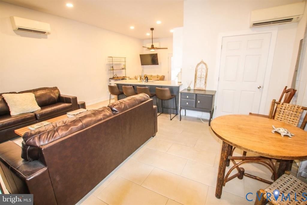 1910 W Main Street, The Historic Fan District, Richmond, VA 23220 Open-concept living space with recessed lighting, tile flooring, kitchen island with seating, and a ceiling fan