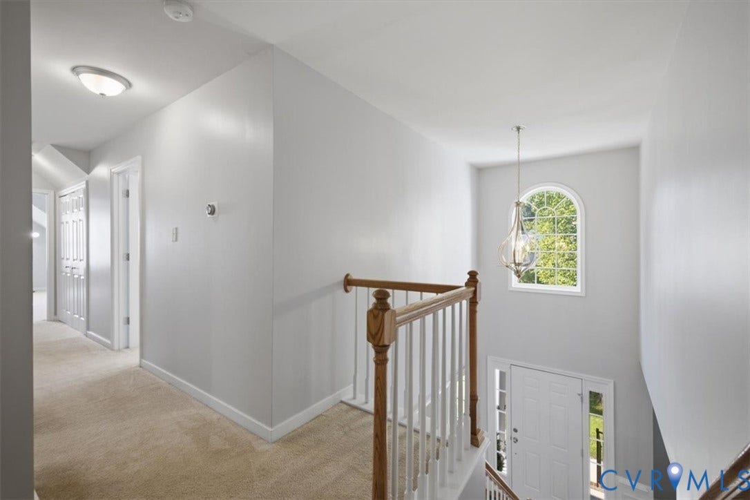 Overlooking foyer from spacious landing area upstairs.  Palladian window creates abundant light