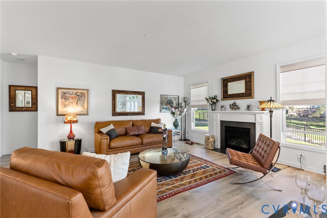 12906 Craftsbury Court, Midlothian, VA 23112 Living area featuring wood-finish flooring, a white mantel, and a fireplace with a dark surround