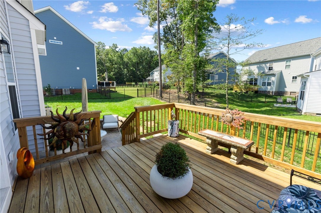 12906 Craftsbury Court, Midlothian, VA 23112 Wood-finish deck with wooden railings, a paved patio, and a fenced backyard
