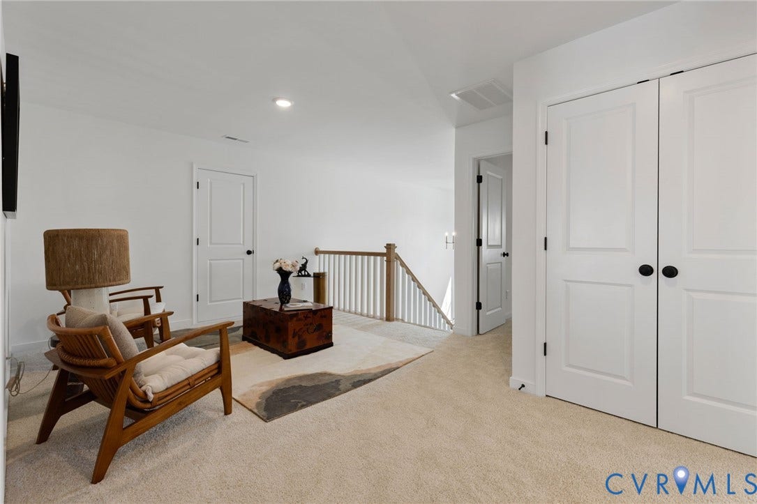 12906 Craftsbury Court, Midlothian, VA 23112 Neutral-toned carpeting, white walls, white paneled doors with matte black hardware, and light wood stair railing
