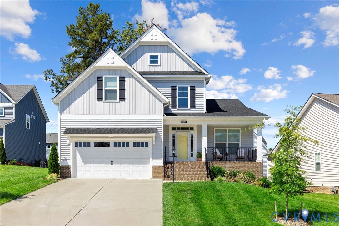 12906 Craftsbury Court, Midlothian, VA 23112 Light gray siding with dark shutters, covered front porch, white garage door, concrete driveway, and a front lawn