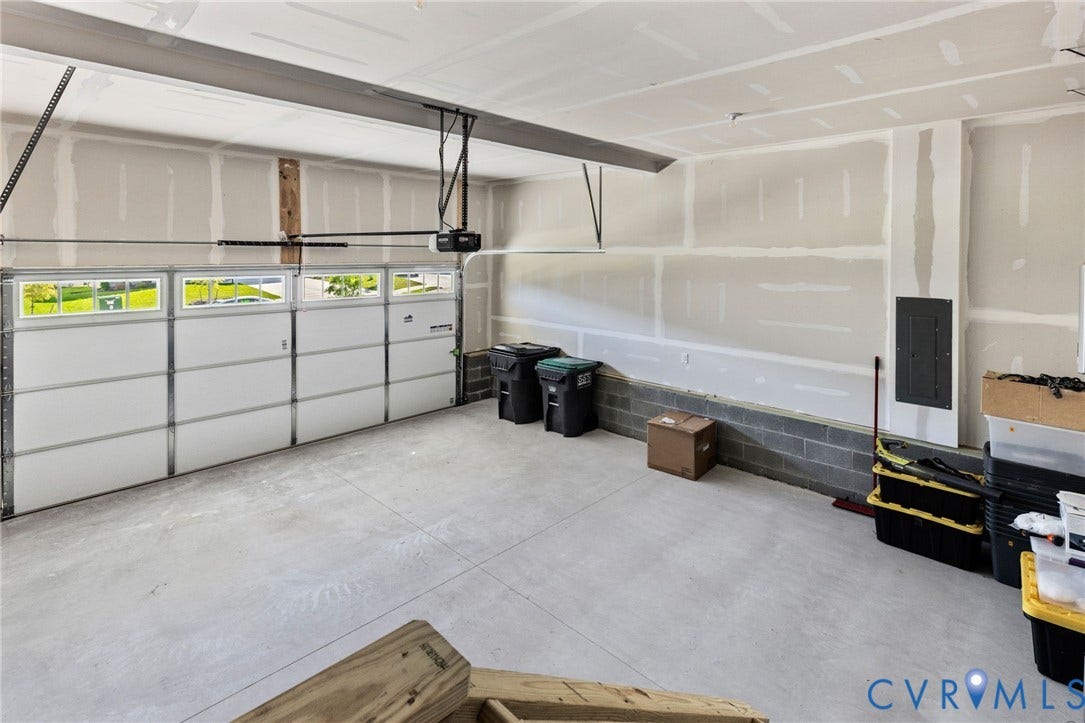 12906 Craftsbury Court, Midlothian, VA 23112 Automated garage door with upper-panel windows, concrete flooring, and unfinished drywall walls