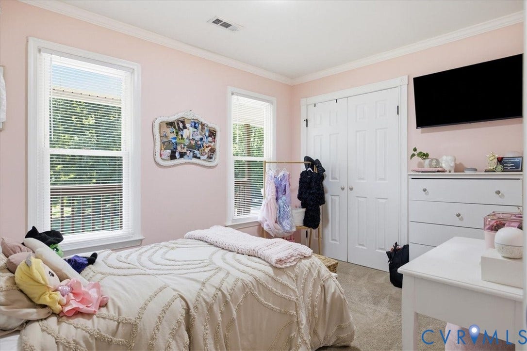 7900 Valencia Road, Chesterfield, VA 23832 Dual windows with white blinds, white trim, crown molding, double-door closet, and wall-mounted television