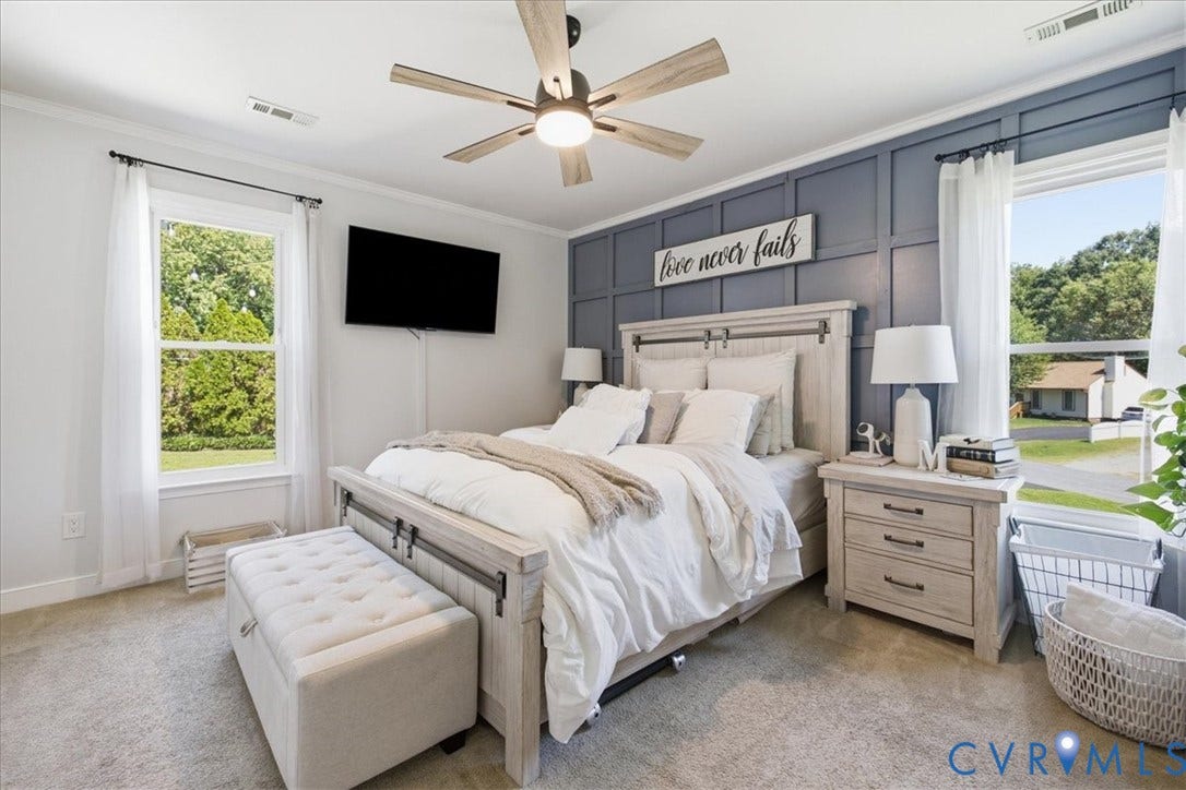 7900 Valencia Road, Chesterfield, VA 23832 Accent wall with grid paneling, ceiling fan with integrated lighting, wood-finish flooring, two large windows, crown molding