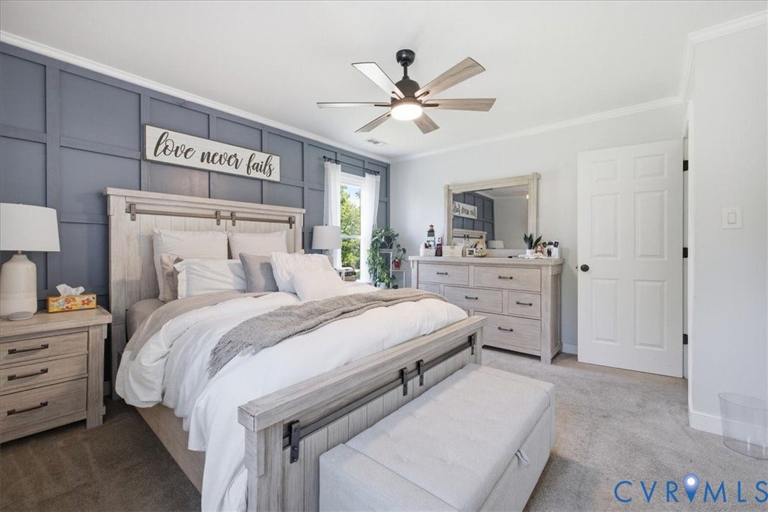 7900 Valencia Road, Chesterfield, VA 23832 Board and batten accent wall, ceiling fan with integrated lighting, wood-finish flooring, paneled interior door, and crown molding