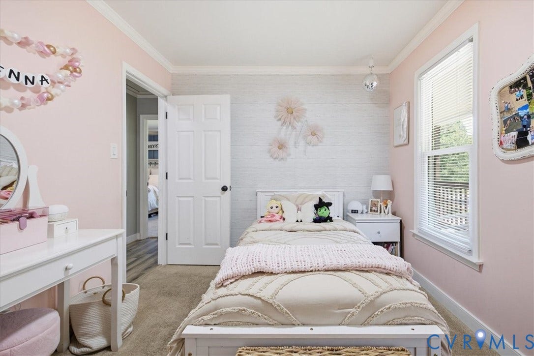 7900 Valencia Road, Chesterfield, VA 23832 Bedroom featuring light pink walls, a white paneled accent wall, and crown molding