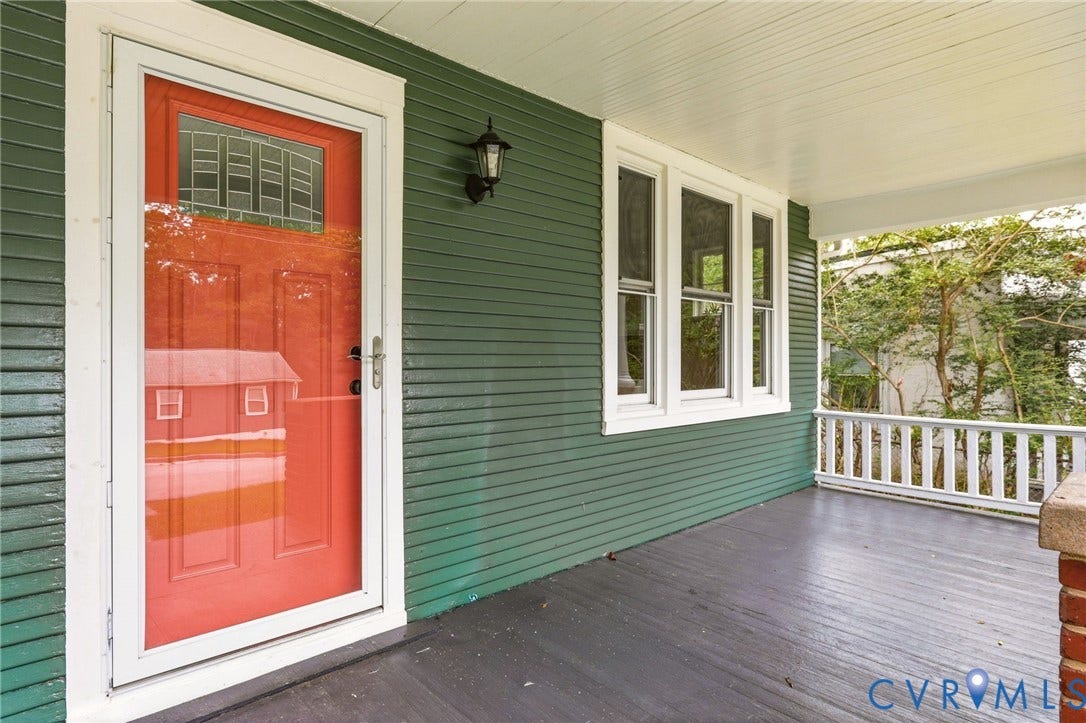 1815 Carlisle Avenue, Richmond, VA 23231 Covered porch with painted wood flooring, green horizontal siding, white trim, and an exterior wall lantern