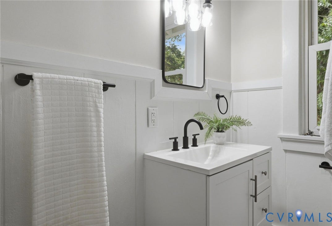 1815 Carlisle Avenue, Richmond, VA 23231 White vanity with an integrated sink, matte black faucet, and modern hardware