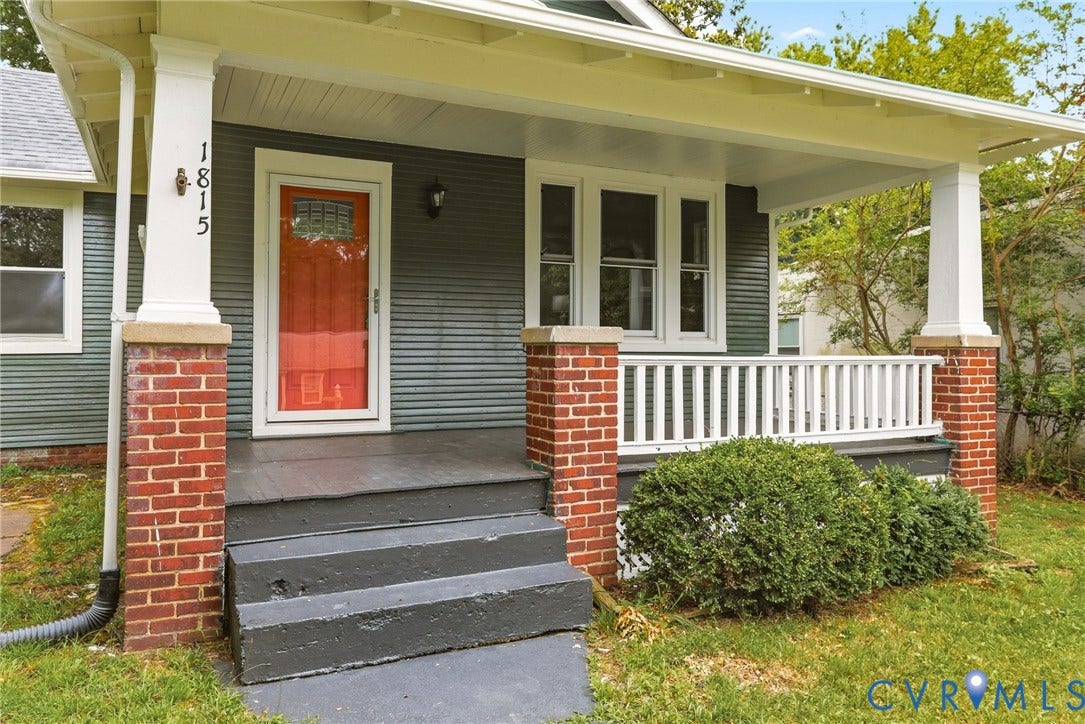 1815 Carlisle Avenue, Richmond, VA 23231 Front porch with brick columns, white railings, and an orange entry door