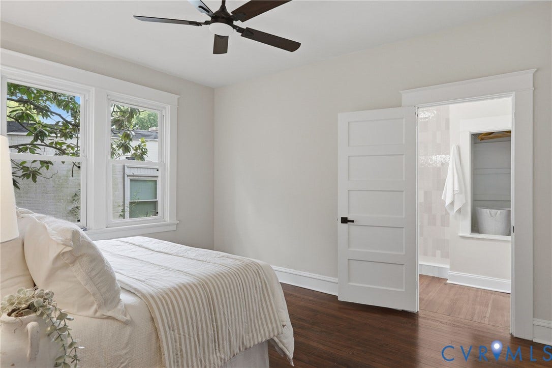 1815 Carlisle Avenue, Richmond, VA 23231 Hardwood-finish flooring with white baseboards, a ceiling fan with dark blades, and white trim windows