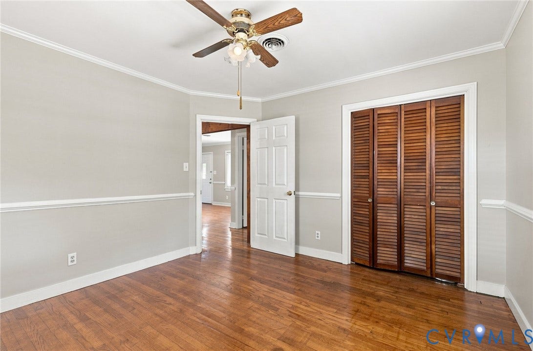 2707 Academy Road, Powhatan, VA 23139 Hardwood flooring, crown molding, chair rail, ceiling fan, and louvered bifold closet doors