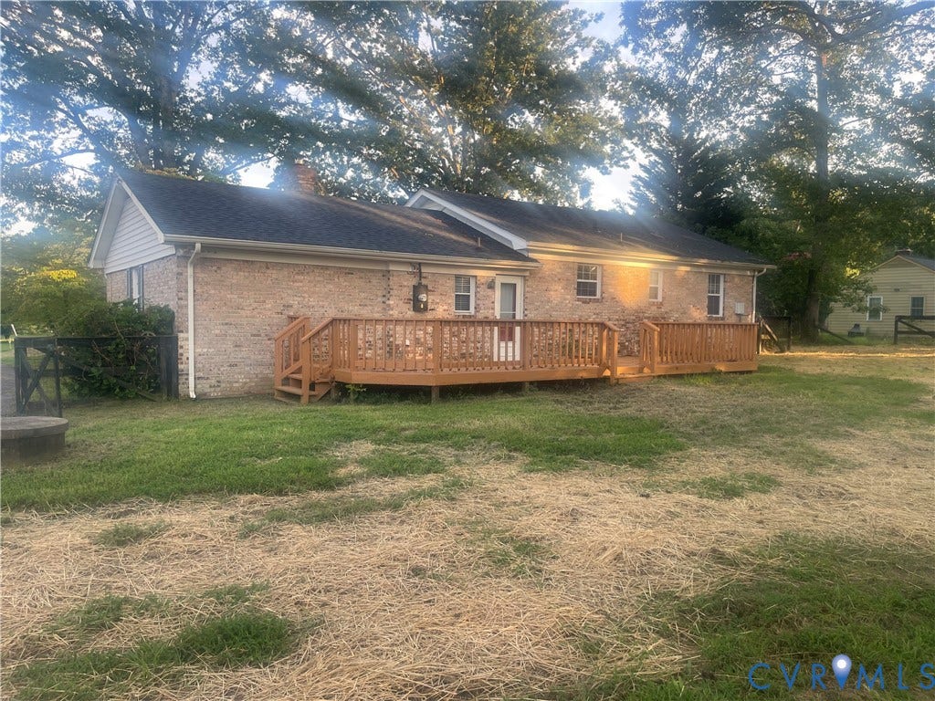 2707 Academy Road, Powhatan, VA 23139 Brick exterior featuring a wood deck with railings and steps, and a dark shingle roof