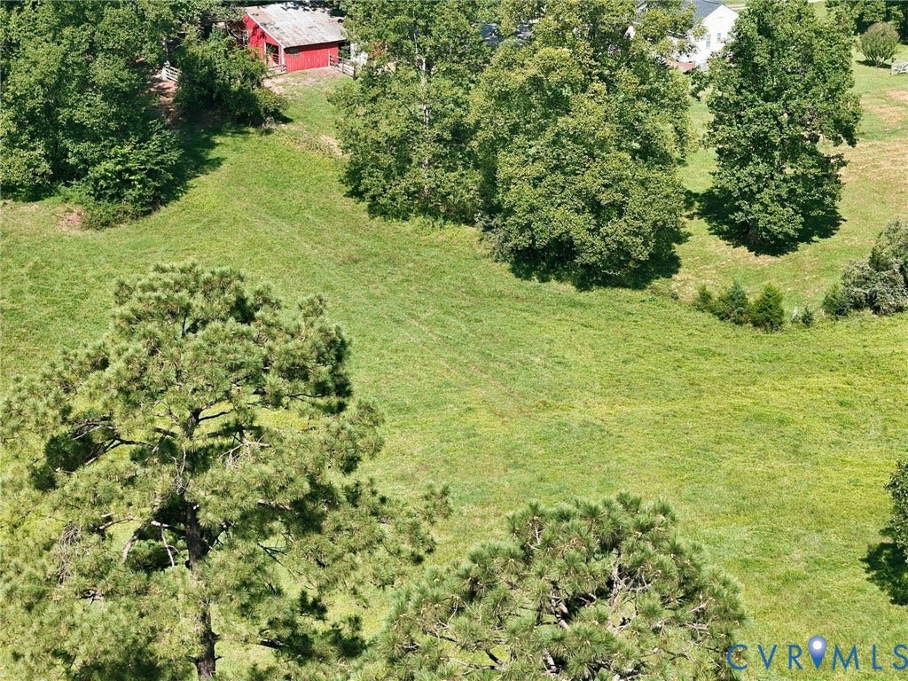 2707 Academy Road, Powhatan, VA 23139 Expansive green lawn with mature trees and a red barn structure