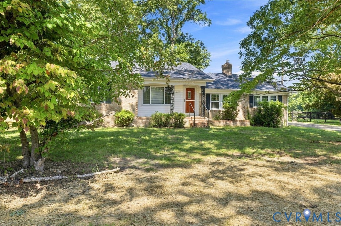 2707 Academy Road, Powhatan, VA 23139 Brick exterior with a red entry door, white trim, dark shutters, and a gray shingle roof