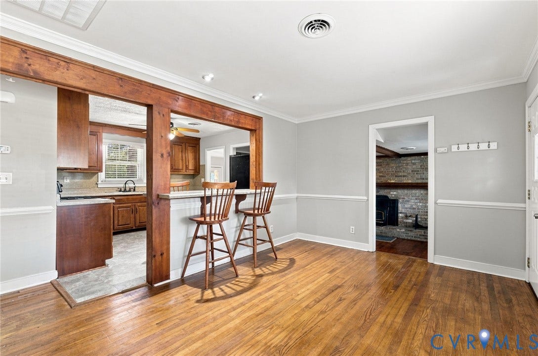 2707 Academy Road, Powhatan, VA 23139 Wood-finish flooring, crown molding, chair rail molding, exposed wood beam, kitchen with wood cabinetry