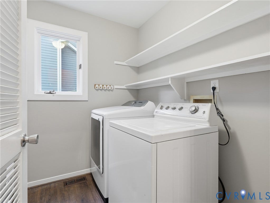 Laundry area featuring built-in shelving, a window, wood-finish flooring, and light gray walls