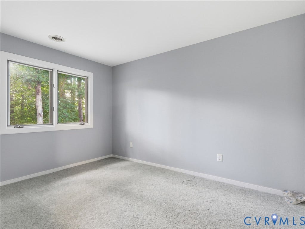 Light gray wall paint, white trim, and light gray carpeting