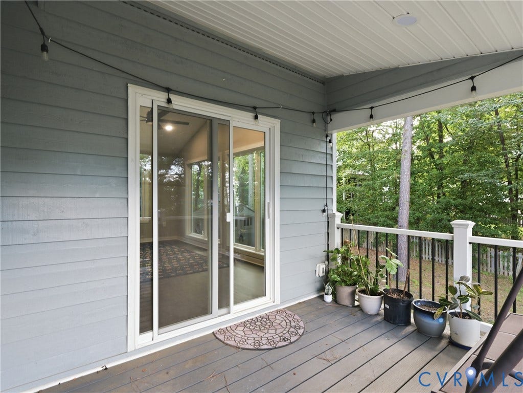 Covered outdoor deck with a sliding glass door and durable composite decking