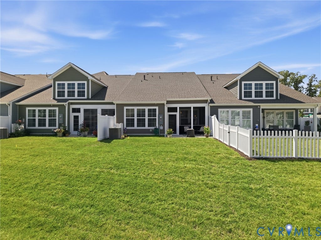 9220 Cerulean Place, Mosaic At West Creek, Goochland, VA 23238 Expansive green lawn with a white picket fence, screened patio, and multiple windows across the rear elevation