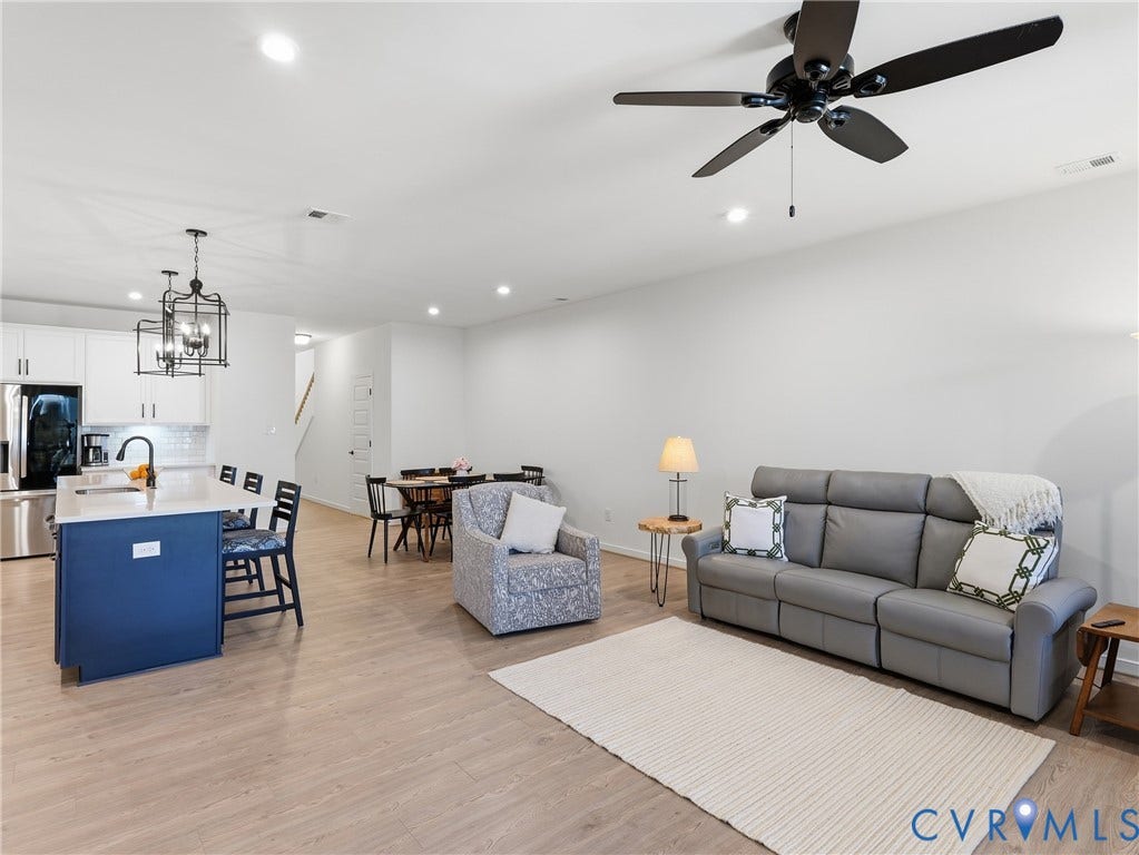 9220 Cerulean Place, Mosaic At West Creek, Goochland, VA 23238 Open concept living space featuring wood-finish flooring, recessed lighting, and a ceiling fan