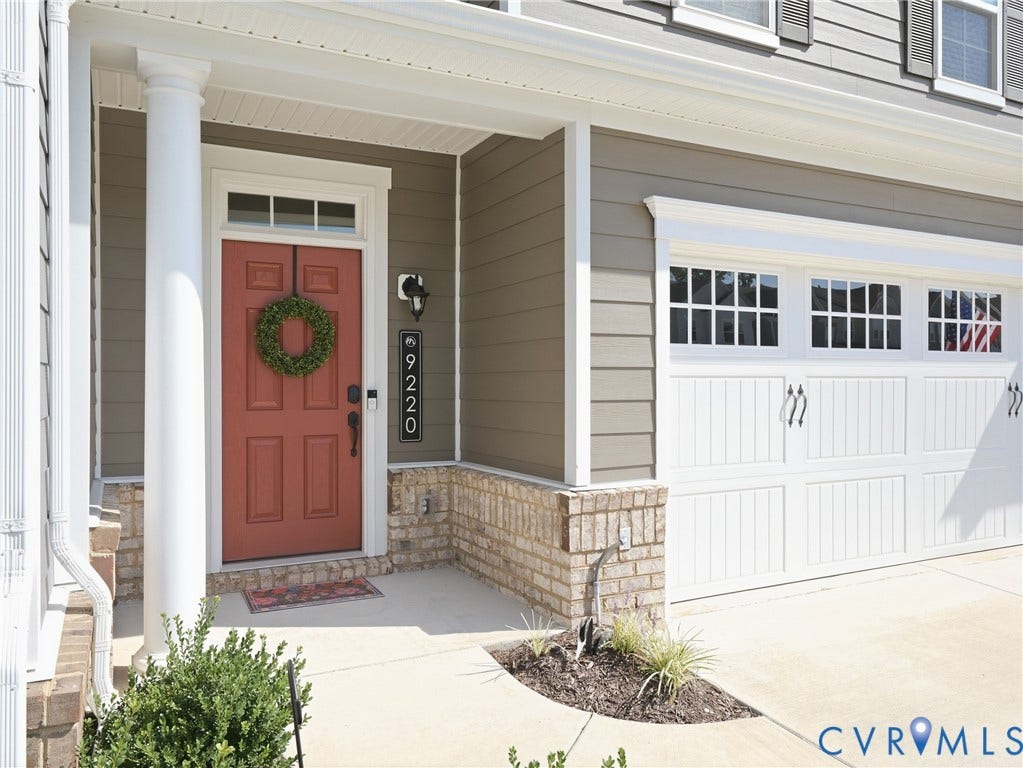 9220 Cerulean Place, Mosaic At West Creek, Goochland, VA 23238 Covered entryway with a paneled front door, transom window, and a fluted column