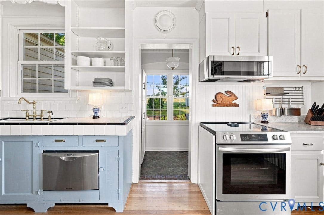 7134 Messer Road, Henrico, VA 23231 White cabinetry with gold-tone hardware, stainless steel appliances, and wood-finish flooring