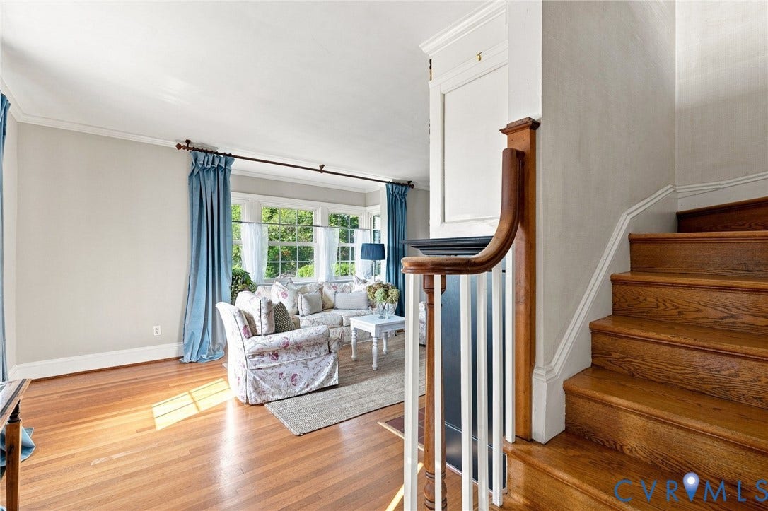 7134 Messer Road, Henrico, VA 23231 Hardwood flooring, painted walls, white crown molding, bay window, and a wood staircase with white risers