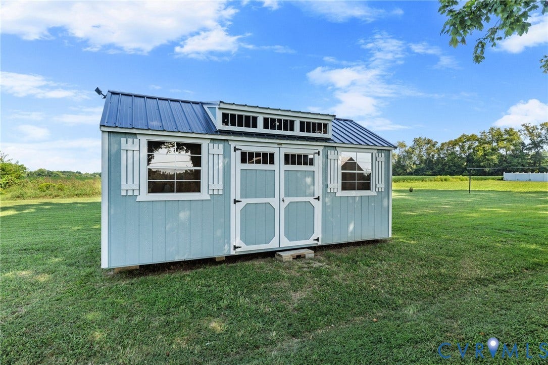 7134 Messer Road, Henrico, VA 23231 She Shed/Storage building featuring horizontal siding, double entry doors, multiple windows, and decorative shutters
