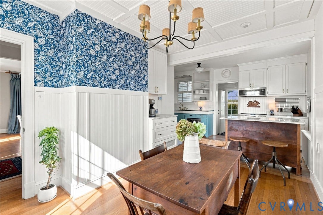 7134 Messer Road, Henrico, VA 23231 Hardwood flooring, coffered ceiling, white wainscoting, and an open-concept kitchen with white cabinetry and a wood-finish island