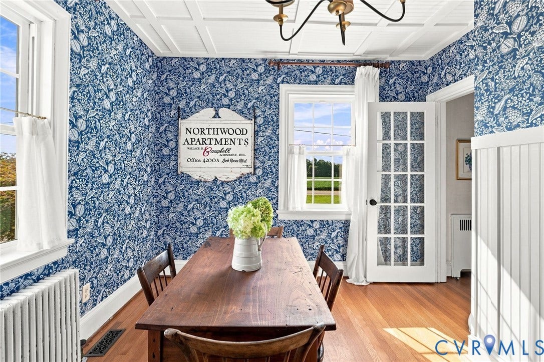 7134 Messer Road, Henrico, VA 23231 Hardwood flooring, wainscoting, coffered ceiling, French-style door, and window with a white frame
