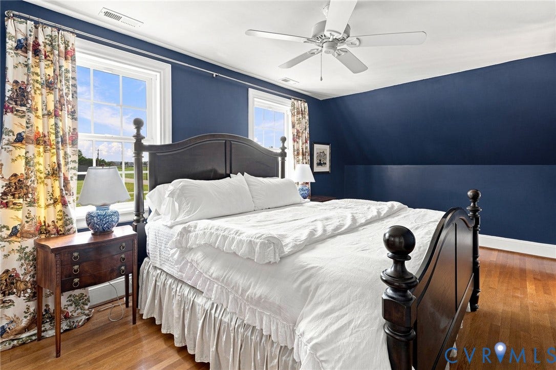 7134 Messer Road, Henrico, VA 23231 Hardwood flooring, painted walls, two large windows, ceiling fan, and built-in architectural detail
