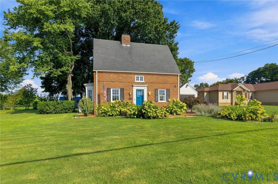 7134 Messer Road, Henrico, VA 23231 Brick exterior with a gabled roof and a vibrant blue entry door