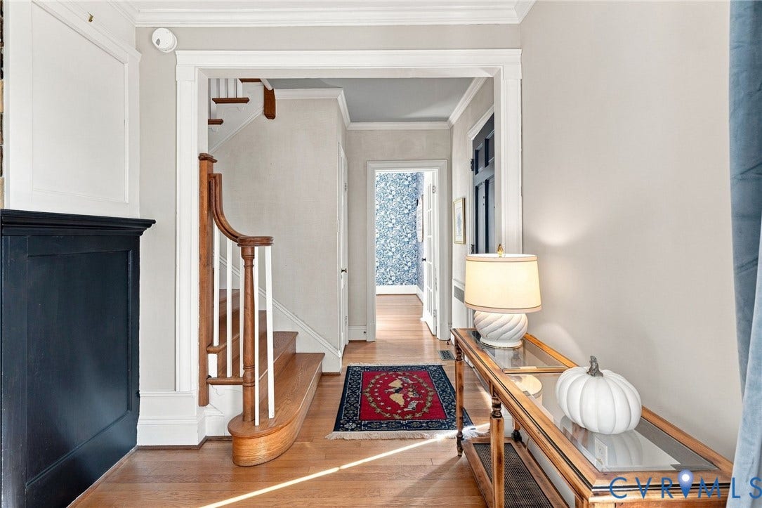 7134 Messer Road, Henrico, VA 23231 Hardwood flooring, staircase with wood handrail and white balusters, crown molding, and framed doorway