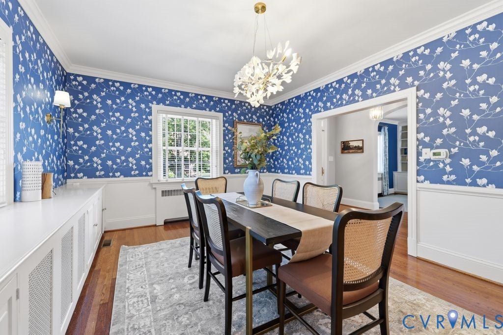 4117 W Franklin Street, Malvern Gardens, Richmond, VA 23221 Hardwood flooring throughout, crown molding, chair rail paneling, decorative wall sconce, and a distinctive chandelier