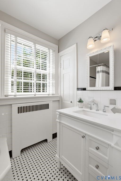 4117 W Franklin Street, Malvern Gardens, Richmond, VA 23221 White vanity with an integrated sink and chrome fixtures