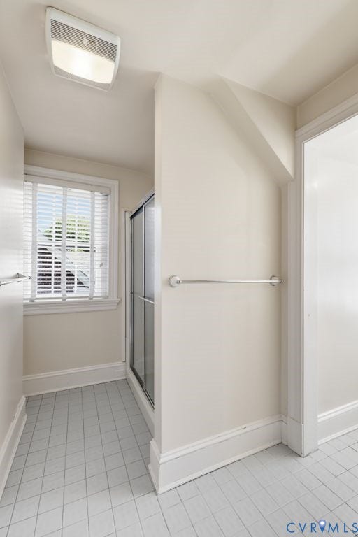 4117 W Franklin Street, Malvern Gardens, Richmond, VA 23221 Bathroom featuring tiled flooring, a window with blinds, a shower enclosure with a sliding glass door, and a built-in ceiling light fixture