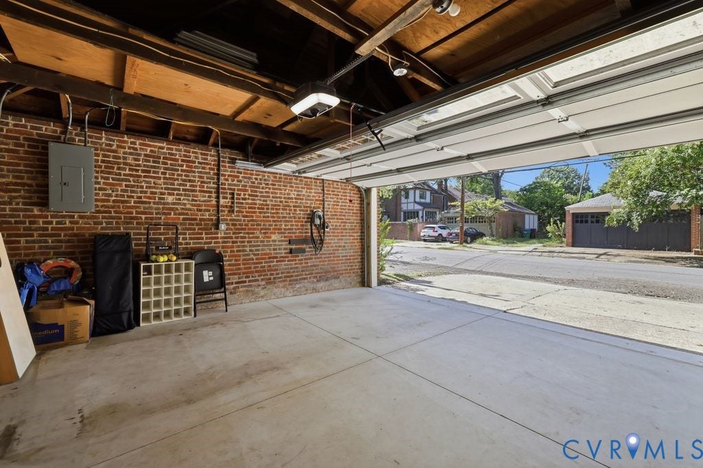 4117 W Franklin Street, Malvern Gardens, Richmond, VA 23221 Concrete flooring with exposed brick walls, overhead lighting, and an electric vehicle charging station