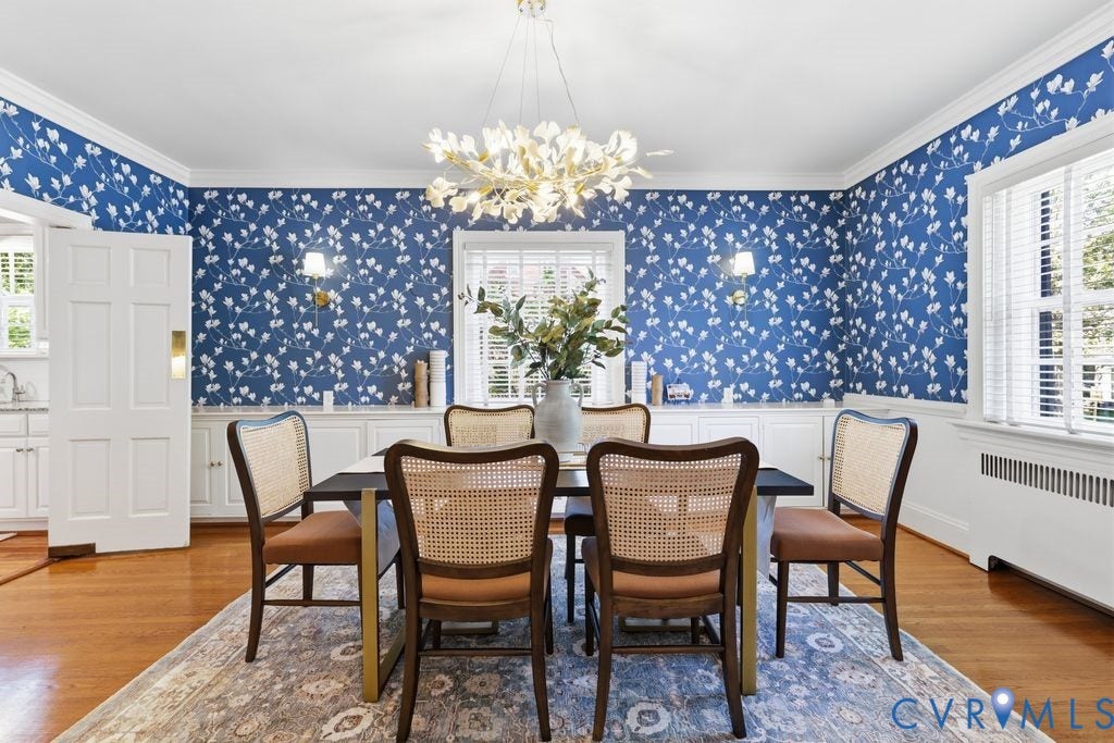 4117 W Franklin Street, Malvern Gardens, Richmond, VA 23221 Hardwood flooring with a patterned area rug, white built-in cabinetry, and a decorative ceiling light fixture