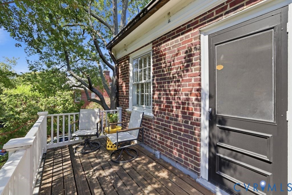 4117 W Franklin Street, Malvern Gardens, Richmond, VA 23221 Outdoor deck with wood-finish flooring, white railing, and a brick exterior wall