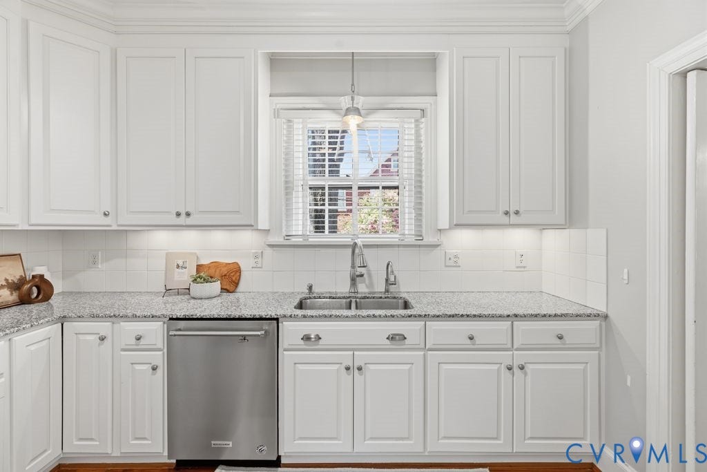 4117 W Franklin Street, Malvern Gardens, Richmond, VA 23221 White shaker-style cabinetry, stainless steel dishwasher, speckled countertops, undermount double-basin sink, and a tiled backsplash
