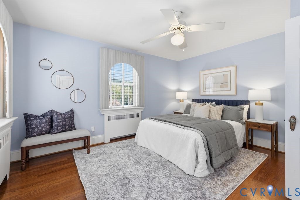 4117 W Franklin Street, Malvern Gardens, Richmond, VA 23221 Hardwood flooring, arched window with integrated blinds, ceiling fan with integrated lighting, wall-mounted radiator, and built-in window seat