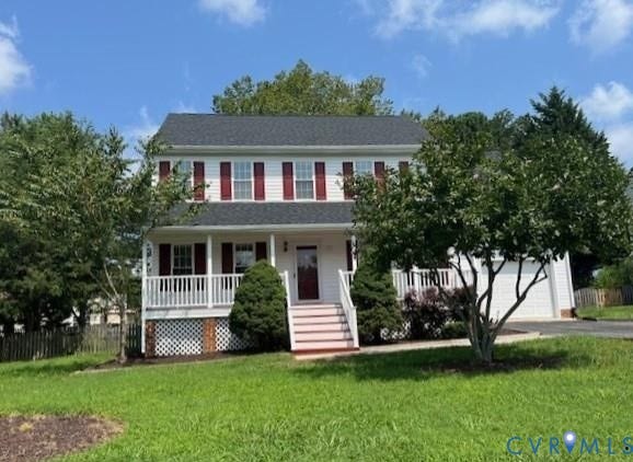 Classic two-story colonial featuring red and white vertical siding, a covered front porch with white railings, brick foundation, and a welcoming entry staircase