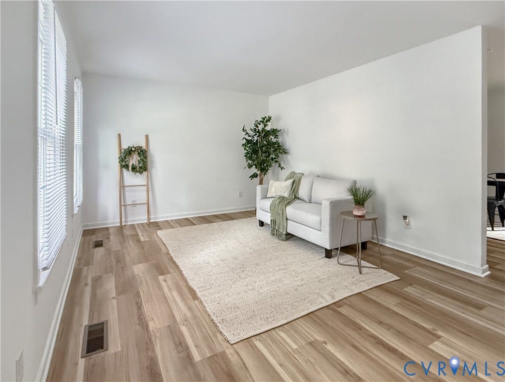 3203 Roland View Terrace, Chester, VA 23831 Light wood-finish flooring, white painted walls, and multiple windows with blinds