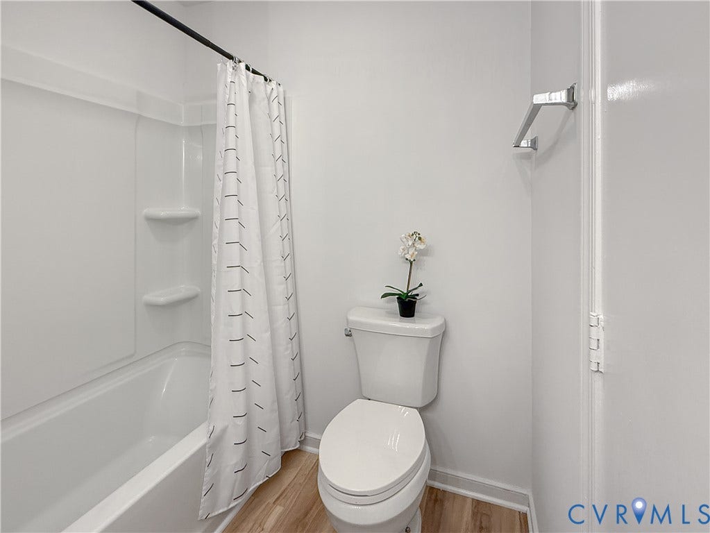 3203 Roland View Terrace, Chester, VA 23831 White tub and shower combination with integrated shelving